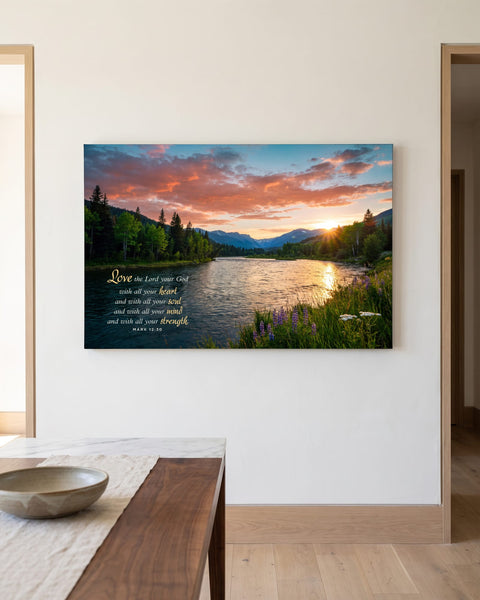 River sunset canvas with the Mark 12:30 verse hanging on a warm white plaster wall beside a walnut and marble table
