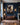Roman soldier carrying the cross canvas above a leather chesterfield in a navy panelled drawing room