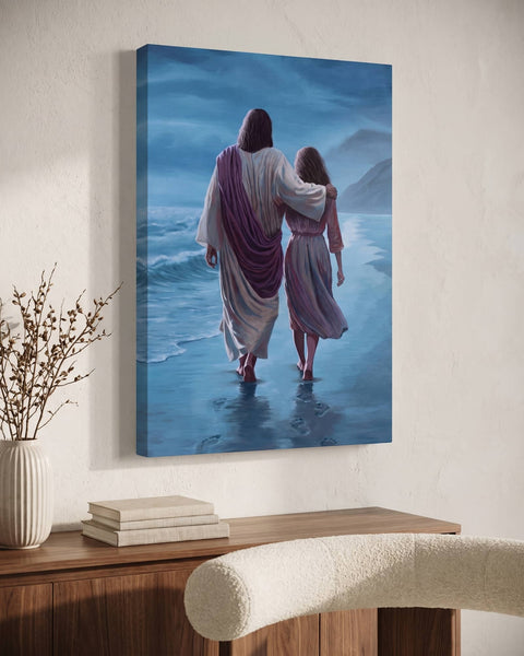 Jesus and a young woman walking the shoreline, blue oil painting on gallery-wrapped canvas above a walnut console