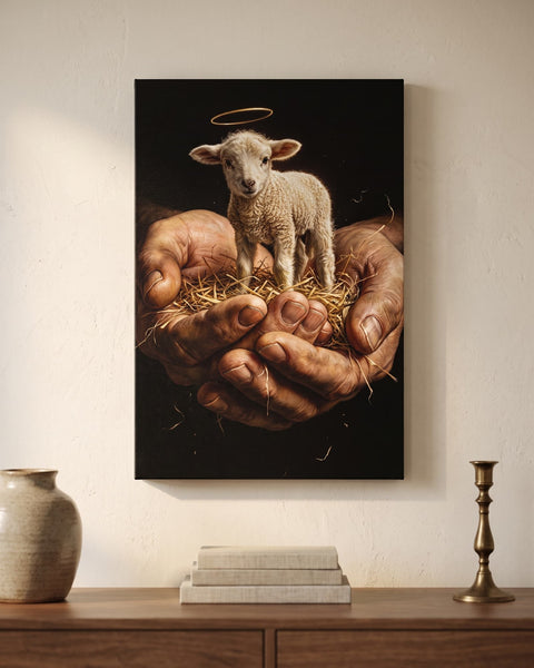 Lamb of God canvas print with gold halo held in cupped weathered hands, hung above a walnut console