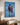 Jesus and a young woman walking the shoreline, blue oil painting on gallery-wrapped canvas above a walnut console