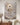 White sculptural impasto canvas of Jesus walking into a wave, hung above a walnut console