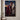 Forgiven canvas print hanging on a pale plaster wall above a low walnut console holding an olive branch in a stoneware vase