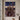 Kneeling soldier artwork hung alone on a warm plaster wall in a Mediterranean-style villa