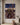 Kneeling soldier artwork hung alone on a warm plaster wall in a Mediterranean-style villa