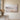 Misty meadow and lake landscape canvas with Be Still and Know Psalm 46:10 hanging on an oat limewashed plaster wall