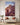 Large Jehovah Jireh ram canvas centered above a cream loveseat in a Mediterranean living room