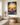 Lost lamb Christian canvas wall art hung above a light oak console in a farmhouse living room, morning light across the shiplap wall