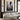 Christian canvas of Christ reaching down in the mud hanging above a cream linen sectional in a panelled living room with brass sconces