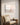 Minimalist Jesus canvas above a caned reading chair with an open Bible and morning coffee