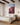 Genesis 22 ram artwork above an oak bed in a sunlit primary bedroom