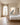 Christ walking in sand canvas above an oak platform bed with white linen