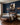 Roman soldier canvas above a carved walnut bed with charcoal linen