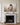 Canvas of Christ cradling a lamb centered above a carved Carrara marble mantel in a Georgian sitting room