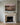 Jesus and the children canvas set into the millwork panel above a carved limestone fireplace