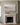 Be Still and Know landscape canvas above a honed limestone fireplace in a sage-grey panelled sitting room
