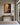 Christ delivering a tormented man canvas above a walnut console table in a Federal townhouse entry foyer