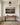 Landscape canvas above an oak console table in a panelled entrance hall with a brass lantern