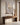 Textured Christian canvas above a walnut console with alabaster bowl and dried branches