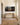 Extra-wide lost lamb canvas on a hallway wall above an oak console