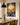 Christian wall art of the ninety-nine and the one hanging in a farmhouse dining room with a black pendant light