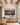 The canvas on the dining room wall above an oak sideboard, beneath exposed ceiling beams