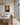 Warm umber canvas of the healing touch on a wainscoted dining room wall beside tall coastal windows