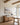 Misty lake landscape canvas above an oak sideboard with dried lavender in a board-and-batten dining room