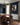 Christian canvas on a navy panelled wall beside a walnut dining table