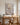 White impasto Jesus canvas behind an oak writing desk in a calm home office