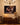 Christian canvas above an oak sideboard lit by candles in a traditional dining room