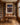 The artwork above a writing desk in an oak-panelled study lined with old books