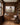 Christ and the lamb canvas on oak panelling above a credenza in a book-lined study