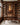 The hem of His garment canvas on a walnut panelled wall above a desk in a book-lined study