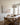Wide coastal canvas beside an oval oak dining table with woven chairs