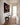 The Missing Piece canvas seen at an angle down a bright board-and-batten hallway