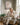 Woman praying with coffee and Bible beneath a Jesus walking on water canvas