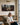 Woman reading her Bible beneath a panoramic Jesus and lamb canvas