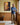 A man in his fifties standing beside the deliverance canvas on an oak panelled upstairs landing