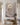 Textured Jesus canvas above a slim oak bench with linen throw and olive tree in a hallway