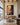 Large 32 by 48 inch deliverance canvas on a double height plaster wall above an oak credenza in a lake house great room