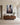 Large 32 x 48 inch canvas of Jesus reaching into the mud on a wide plaster wall above a long walnut credenza in a great room