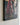 Close view of a lower corner showing the 1.25 inch gallery-wrapped edge with the painted image continuing around the side of the frame
