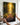 Hands holding the gallery-wrapped canvas against the wall before hanging it