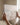Hands holding the gallery-wrapped canvas by its edges before hanging it