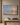 Be Still and Know painting-style canvas of an ocean sunrise with low waves on an empty beach, hanging on a taupe plaster wall