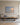 Psalm 46:10 painting-style canvas of a beach at sunrise above a linen sofa in a bright living room