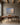 Bible verse painting-style canvas of gentle waves and a rising sun hanging above a walnut writing desk in a home office