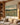Wildflower meadow canvas with Bible verse text in a warm Craftsman-style family room with oak built-ins