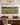 Be Still And Know That I Am God canvas above a wooden sideboard in a traditional dining room